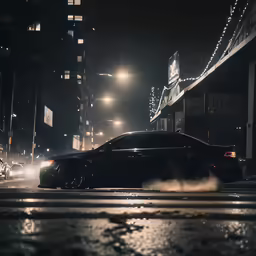 a black car driving down the road at night