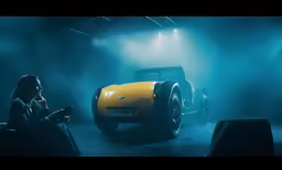a woman sits in a chair next to a yellow sports car
