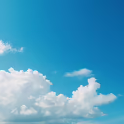 an airplane flying in the sky over the ocean