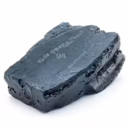 closeup view of black rock covered with black powder
