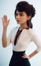 a woman in a white top poses for a picture