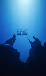 people using their cell phones to take pictures under the water