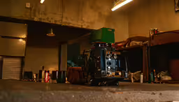 a large green box and some items on top of a table,some parts are laying on a table with items behind it