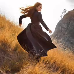 a woman in a long dress in a field