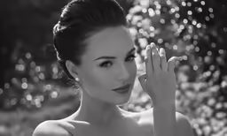 a woman in black and white holds her hands together