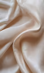 a white fabric with silver glitter and ruffled edges