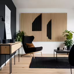 a living room with a black sofa chair and a large bamboo screen