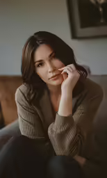 a woman is sitting down in a black and white photo