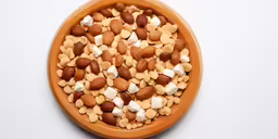 a bowl filled with nuts and other food