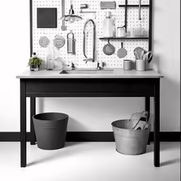 a sink, counter and a shelf with pots and other items