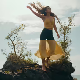 a woman wearing a yellow top and a dress