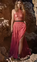 a model wears a strapless dress with sheer layers and high heeled sandals