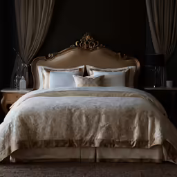 a bed with pillows and a throw pillow and curtains