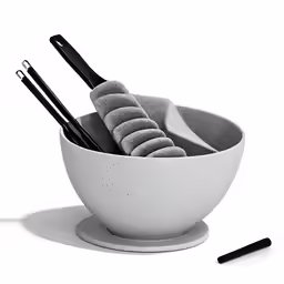 a black and white photo of three black and white chopsticks in a bowl