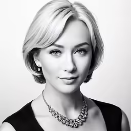a woman is wearing a black top and has her chin shaved back