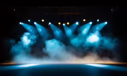 a stage with a lot of lights on it and some smoke