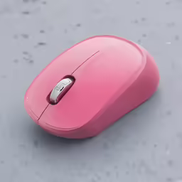 a pink computer mouse laying on the ground