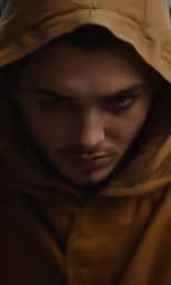 a man in brown jacket looking down at his cell phone