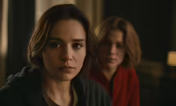 the two women are looking at the camera