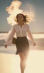 a woman walking on a beach near the ocean