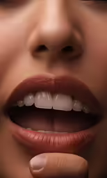 a woman putting tooth paste on her teeth