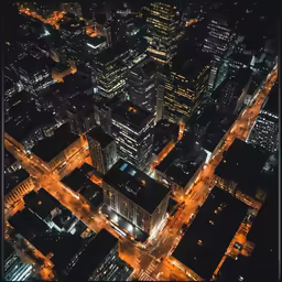 an aerial view at night of many buildings