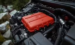 a red engine box sitting inside of a vehicle