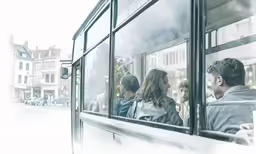 several people on a bus and a dog is looking outside the window