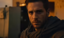 a man in a hoodie staring to his left