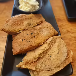 a group of bread sticks and some other foods