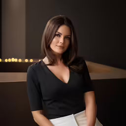 woman with medium hair posing for picture in office