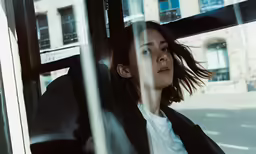 the woman in the bus stares out the window