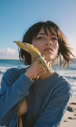 a young lady in the sun is holding onto a large flower