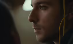 a man looks at a woman through the mirror