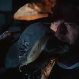 a man is holding a stuffed animal near his face
