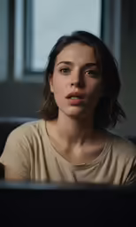 a woman with a puzzled look in front of a laptop computer