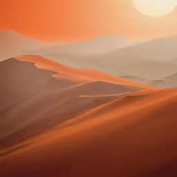 a desert sunset over a mountains range