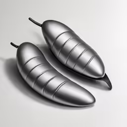 two silver egg halves on a white table