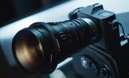 a black camera with a large lens mounted on top