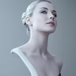 a white female is posing in front of a gray background