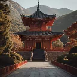 a pagoda with stairs in front of it on top of a hill