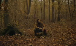 a man in the woods with his feet in the ground