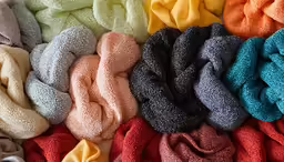 many pieces of fabric sitting together in a box