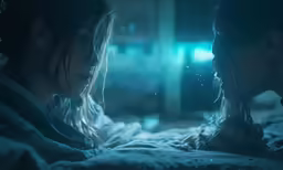 a couple in the bed with their hands together