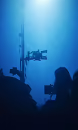 the cameraman takes pictures of something that looks like an image on a tripod