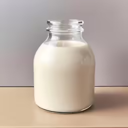 a small glass jar filled with white colored liquid
