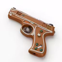a golden colored toy gun on a white surface