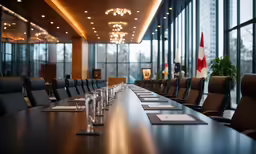a long black conference table next to large windows