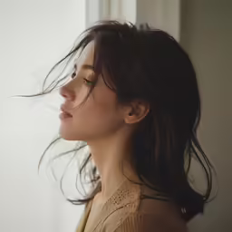 a woman with her hair blowing in the wind