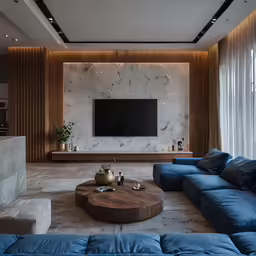 a living room with a blue sectional sofa and a television